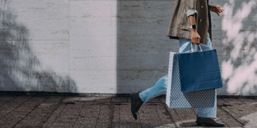 A woman walking down the street with shopping bags