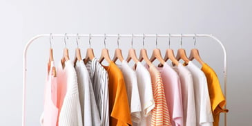 Clothes hanging on a garment rack. 