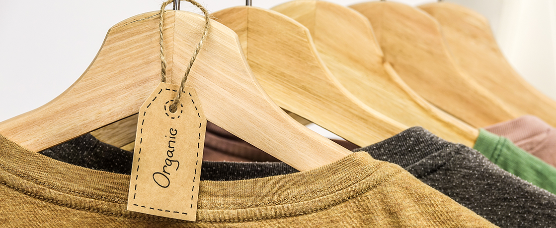 sustainably made organic shirts on wooden hangars